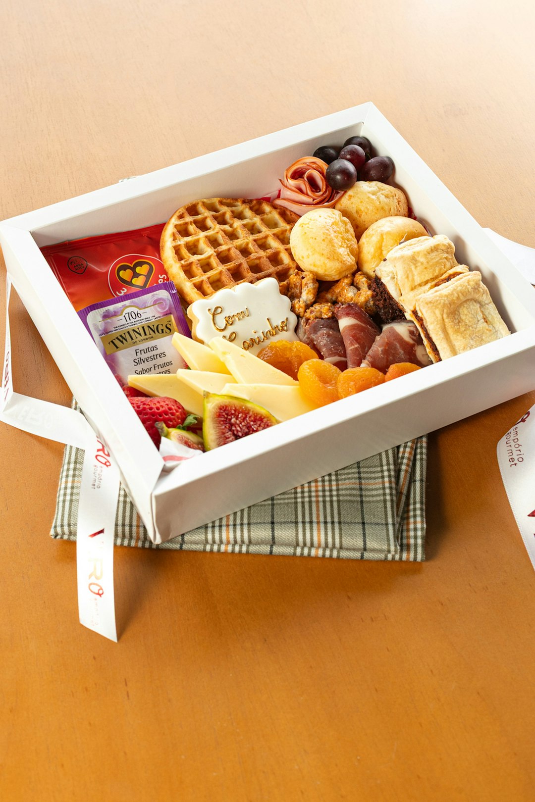 portfolio-01 a-white-box-filled-with-cheese-fruit-waffles-and-snacks-ku67di7hjmw